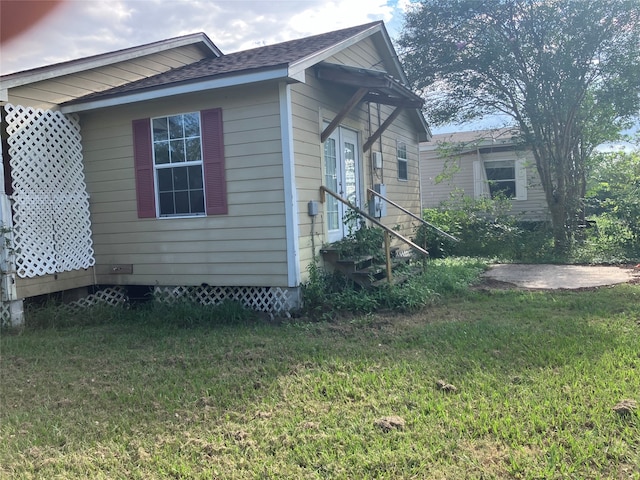 view of property exterior with a lawn