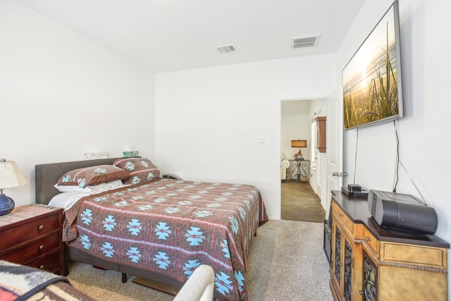 bedroom with dark colored carpet