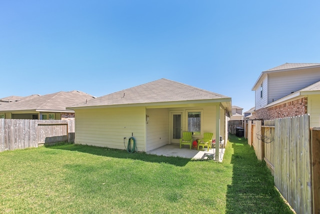 back of house with a patio, a yard, and central air condition unit