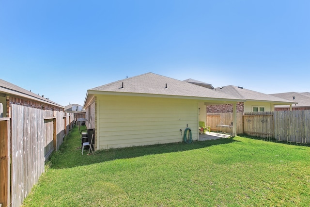 back of property featuring a lawn