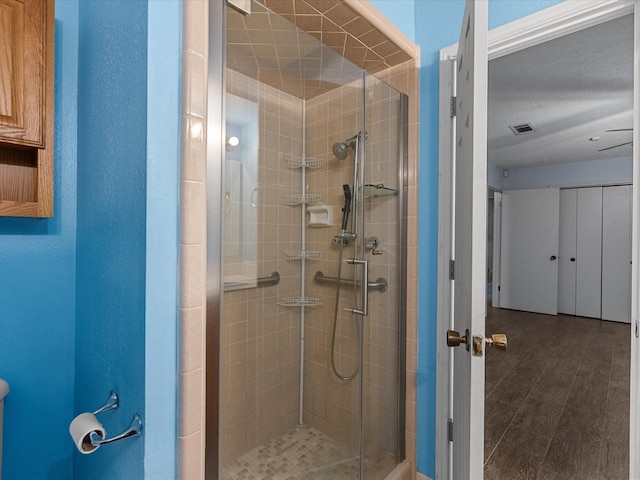 bathroom with hardwood / wood-style floors and walk in shower