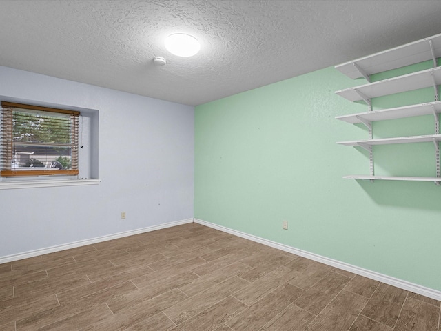 empty room featuring hardwood / wood-style floors and a textured ceiling