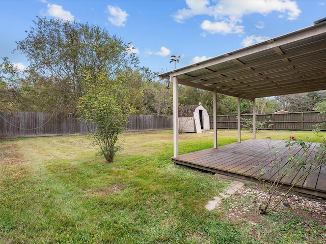 view of yard featuring a storage shed and a deck