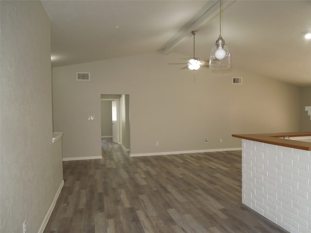 interior space featuring lofted ceiling with beams, ceiling fan, dark hardwood / wood-style floors, and bar area