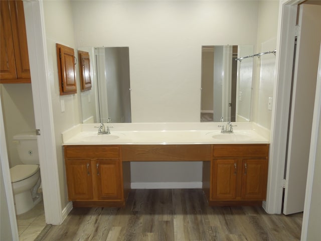 bathroom featuring hardwood / wood-style flooring, vanity, and toilet