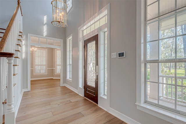 foyer featuring light hardwood / wood-style flooring and a notable chandelier