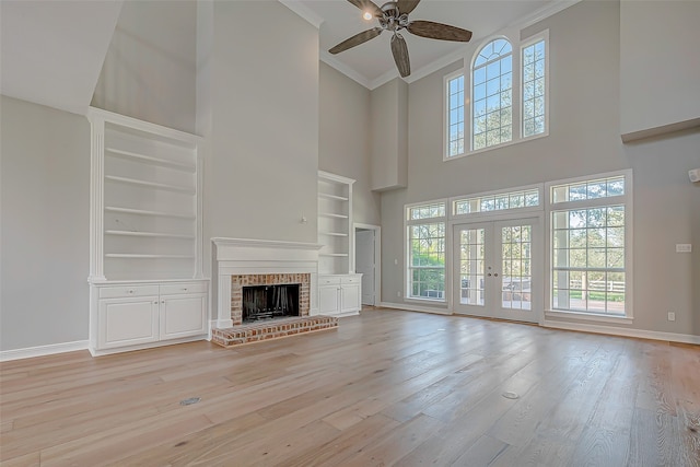 unfurnished living room with plenty of natural light, light hardwood / wood-style floors, and a fireplace