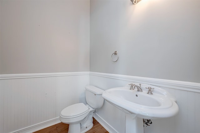 bathroom with sink, hardwood / wood-style floors, and toilet