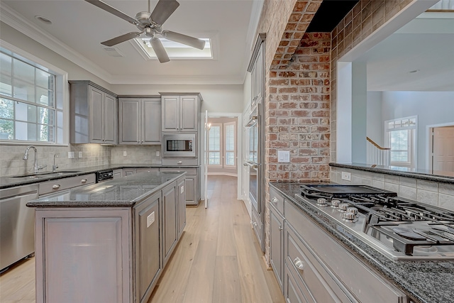 kitchen featuring plenty of natural light, a kitchen island, and stainless steel appliances