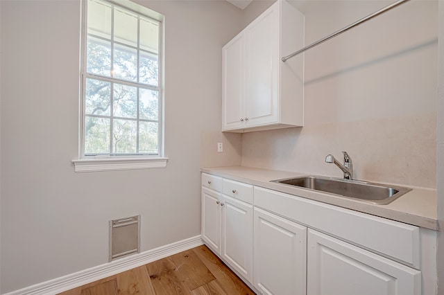 interior space with sink and light wood-type flooring