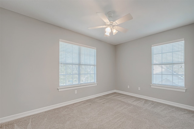 carpeted empty room featuring ceiling fan