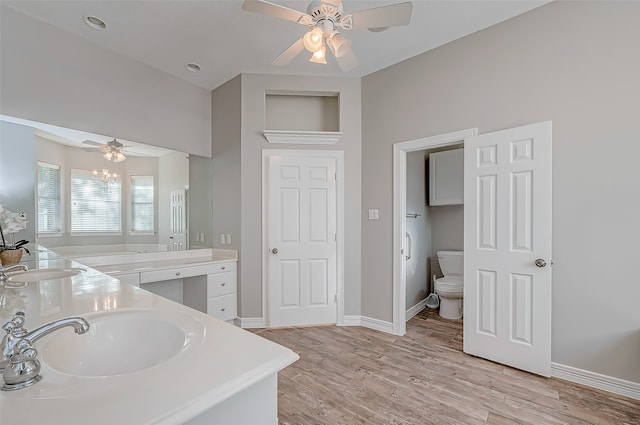 bathroom featuring vanity, ceiling fan, toilet, and wood-type flooring