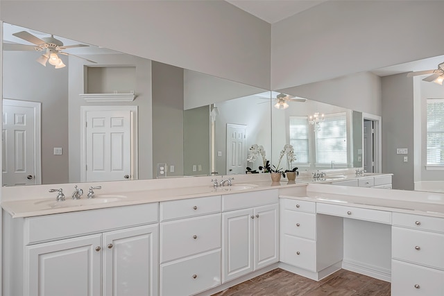 bathroom with hardwood / wood-style floors, vanity, an inviting chandelier, and a healthy amount of sunlight