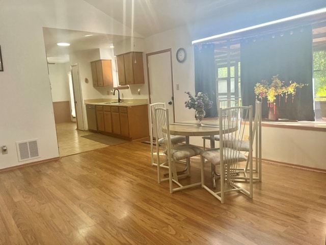 dining area featuring light wood-type flooring and sink