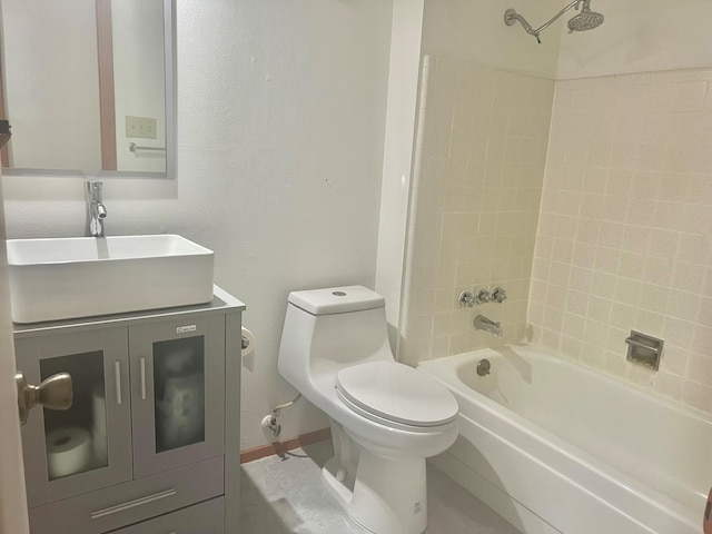 full bathroom featuring vanity, tile patterned flooring, tiled shower / bath, and toilet