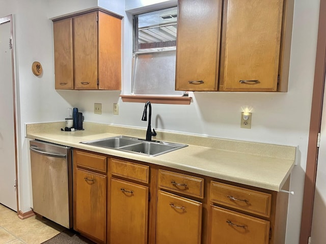 kitchen featuring light tile patterned floors, sink, and stainless steel dishwasher