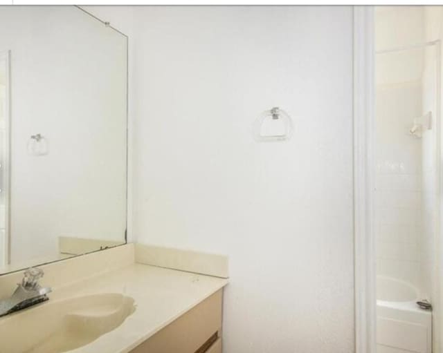 bathroom with vanity and  shower combination