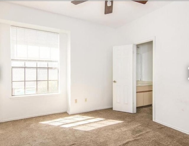 unfurnished bedroom featuring carpet and ceiling fan