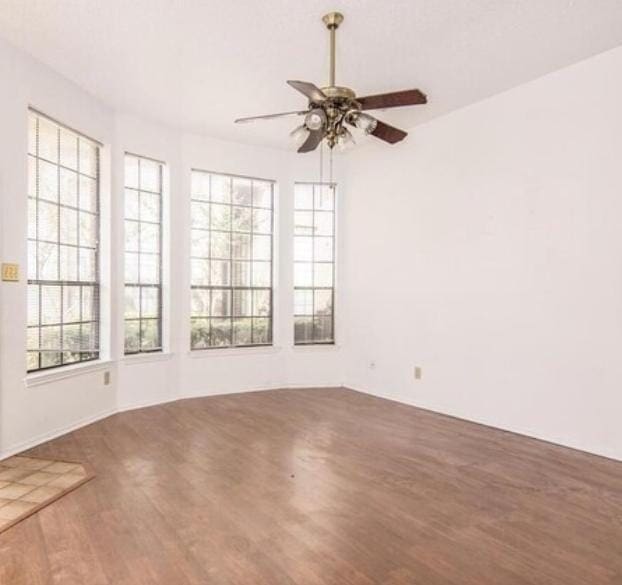 empty room featuring ceiling fan and hardwood / wood-style floors