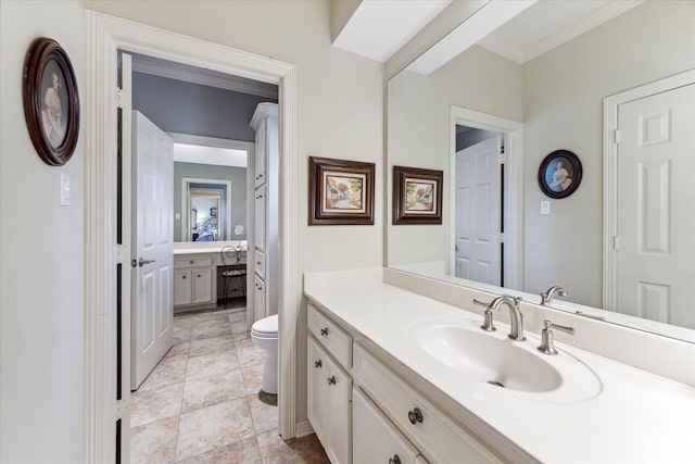 bathroom featuring ornamental molding, vanity, and toilet