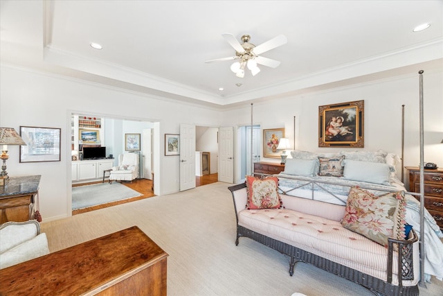 bedroom featuring ornamental molding, a tray ceiling, light colored carpet, and recessed lighting