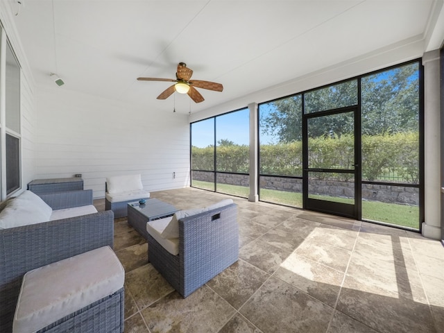 sunroom featuring ceiling fan