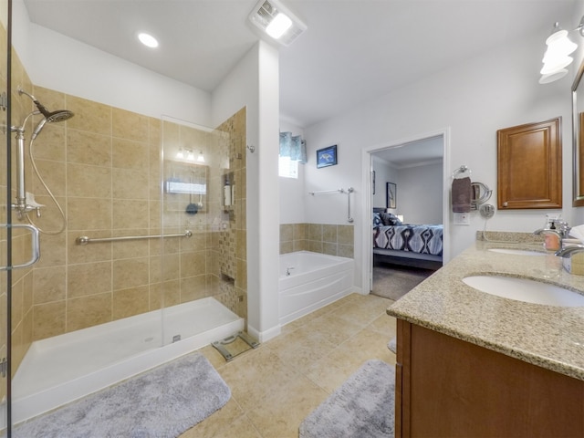 bathroom featuring vanity, shower with separate bathtub, and tile patterned floors