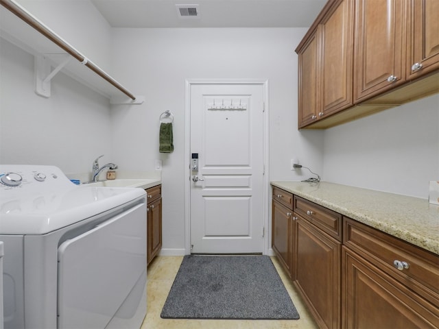 laundry area with washer / clothes dryer, cabinets, and sink