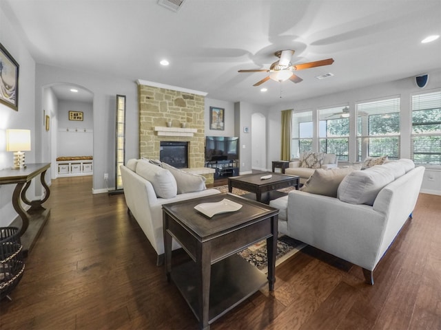 living room with ceiling fan, a fireplace, and dark hardwood / wood-style floors