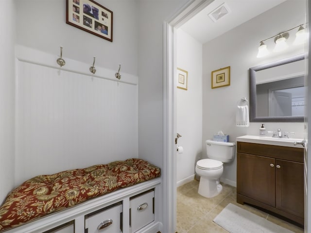 bathroom with tile patterned flooring, vanity, and toilet