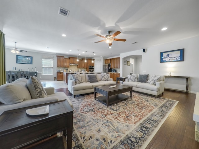 living room featuring hardwood / wood-style floors and ceiling fan