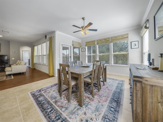 dining space with ceiling fan, ornamental molding, and light hardwood / wood-style floors