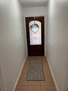 doorway to outside featuring light tile patterned floors