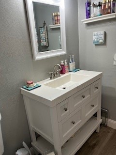 bathroom with vanity and hardwood / wood-style flooring