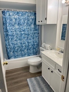 full bathroom featuring shower / bath combination with curtain, hardwood / wood-style floors, vanity, and toilet