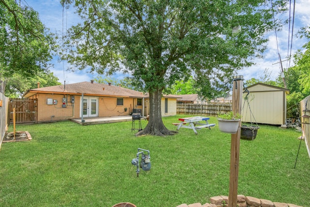 view of yard featuring french doors and a shed