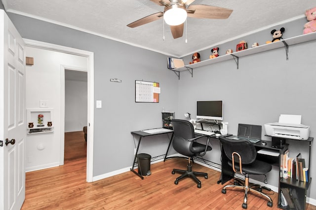 home office with ceiling fan, ornamental molding, a textured ceiling, and light hardwood / wood-style floors