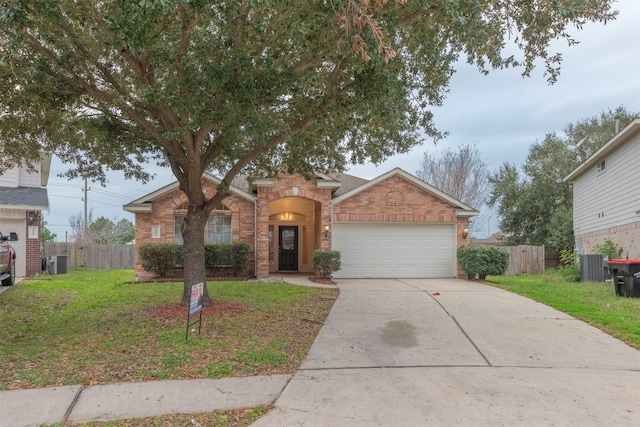 front of property with a garage, central air condition unit, and a front yard