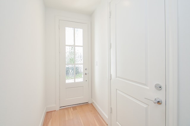 doorway to outside with plenty of natural light and light hardwood / wood-style flooring