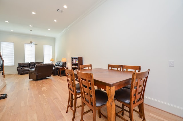 dining area featuring ceiling fan, light hardwood / wood-style flooring, and ornamental molding