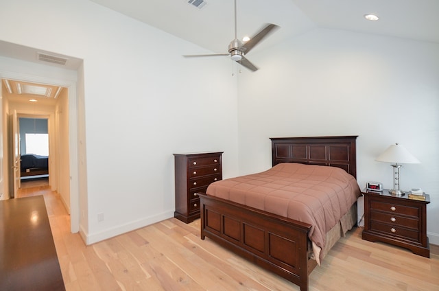 bedroom featuring light hardwood / wood-style floors, vaulted ceiling, and ceiling fan