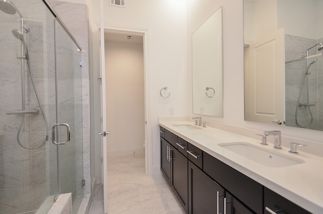 bathroom with vanity and a shower with shower door