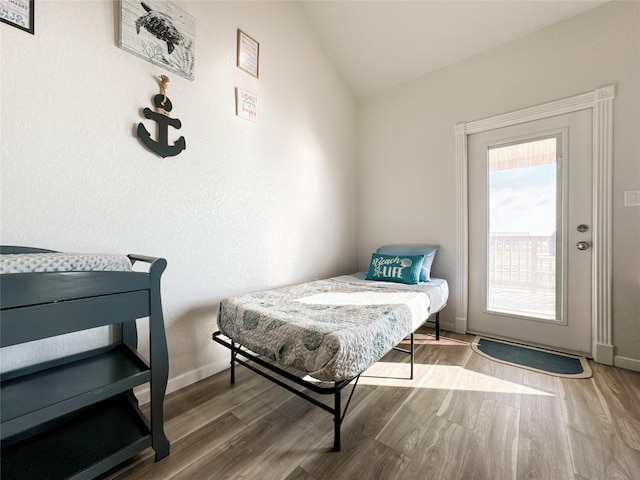 bedroom featuring wood-type flooring and lofted ceiling