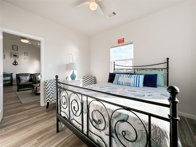 bedroom with ceiling fan and hardwood / wood-style flooring