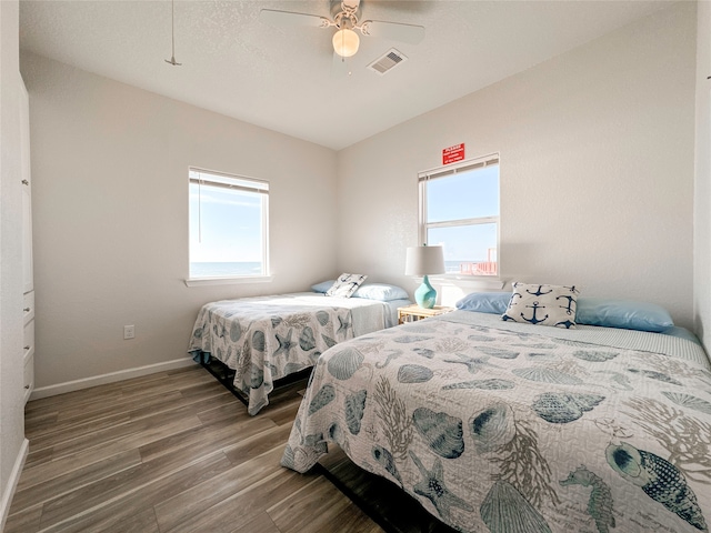 bedroom with ceiling fan and hardwood / wood-style flooring