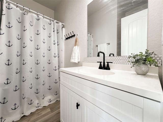 bathroom featuring vanity, hardwood / wood-style floors, and a shower with curtain