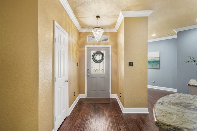 foyer with a chandelier, a textured ceiling, crown molding, and dark hardwood / wood-style flooring