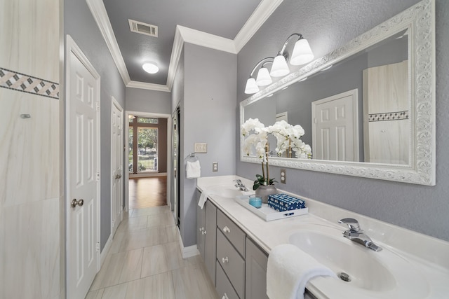 bathroom with ornamental molding, vanity, and tile patterned floors