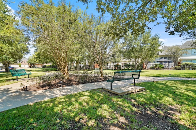 view of property's community with a lawn