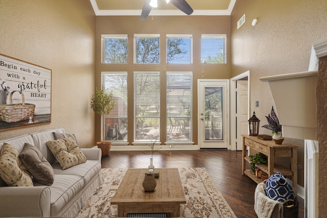 interior space featuring ornamental molding, ceiling fan, and dark hardwood / wood-style flooring